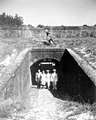 Two officers along with a couple walking through the sally port of Fort Barrancas- Pensacola, Florida (3785409996).jpg