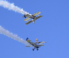The UK Utterly Butterly display team perform wing walking with their Boeing Stearmans in 2006. Utterly Butterly Wing walking.jpg