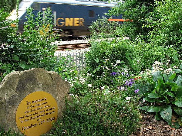 An InterCity 225 passing a memorial garden for the crash victims