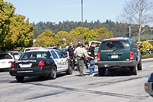 Police officers and sheriff's deputies in Scotts Valley, California arresting a suspect following a police pursuit in 2009 2009-04-06 Scotts Valley Chase 02.jpg