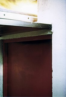 Building Code Violation: No firestop in the cable tray penetration above the fire door in the fire-resistance rated concrete wall. Afterthought firestop.jpg