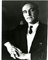 Portrait of Dr. Ernest Ambler in dark jacket and light cardigan with tie