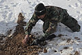 An Afghan National Army Special Forces member with the 8th Special Operations Kandak uncovers a possible improvised explosive device location on a final practical test during the explosive hazard reduction 140111-A-CI200-174.jpg