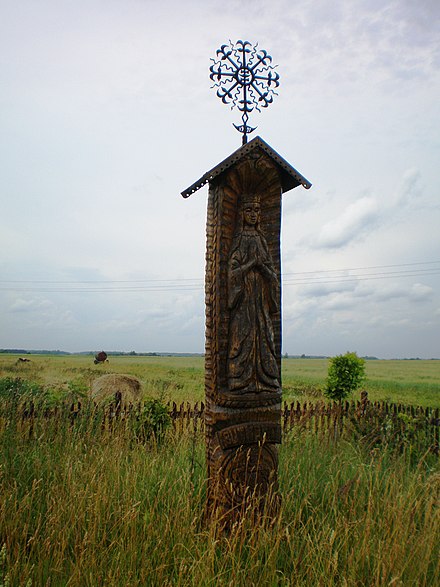 Pre-Christian Baltic Sun and the Moon cross at the top of wooden monument. Christian and pagan traditions are very intertwined in Lithuanian culture.