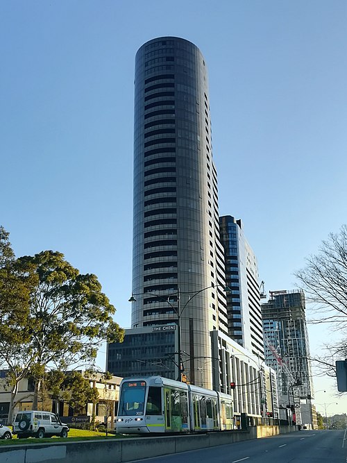 A tram passing high-rise apartment buildings in suburban Box Hill, 14 km east of the CBD