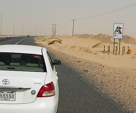 Driving in Kuwait might look like this. Note the "watch out for camels" sign to the right.