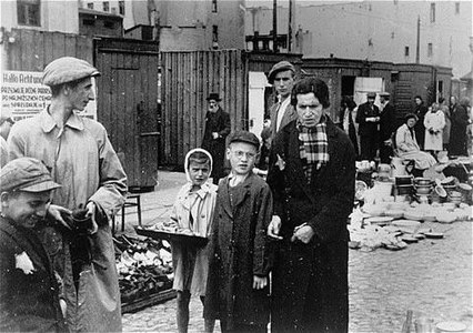 A child tries to sell her wares in an open market in the ghetto