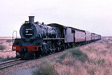 Skoda-built no. 2636 with a domeless boiler and Type MR tender on a passenger train near Vryburg, Northern Cape, October 1971 Class 19D no. 2636.jpg