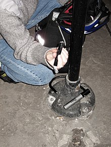 A severed bicycle U-lock lying loose around a street sign pole in Chicago, Illinois has been apparently defeated by bolt cutters. Cut bicycle U-lock.jpg