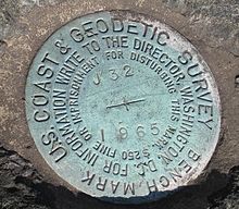Closeup of a United States Coast and Geodetic Survey marker embedded in a large rock in front of the Noroton Volunteer Fire Department in Darien, Connecticut. DarienCTUSCoastAndGeodeticSurvey1965Marker11042007.jpg