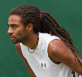 Dustin Brown competing in the third round of the 2015 Wimbledon Qualifying Tournament at the Bank of England Sports Grounds in Roehampton, England. The winners of three rounds of competition qualify for the main draw of Wimbledon the following week.