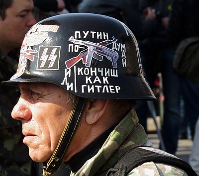 Ukrainian Euromaidan protester wearing Stahlhelm with SS insignia, 2014. The inscription says "Putin, think or you'll end up like Hitler".