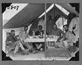 Expedition members in tent with chief (3948019401).jpg