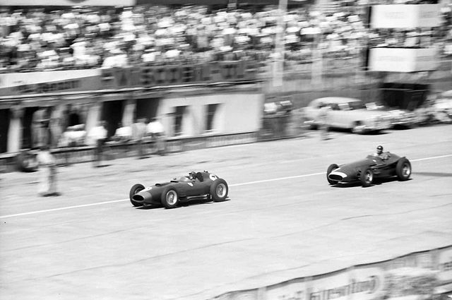 Collins, in a Ferrari 801, is chased by Juan Manuel Fangio's Maserati 250F during the 1957 German Grand Prix.