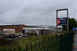 This image depicts a general overlook of a former Esso petrol station, the canopy of which had already been demolished. When Ford was in business here until 2008, this was used as the 'Evans Halshaw Motorhouse', selling low-priced used cars, briefly becoming a hand car wash after the Ford dealer moved away.
