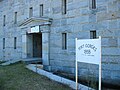 Fort Gorges, Portland, Maine. A sign marks the entrance to the fort from the stone jetty.