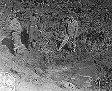 Amerikanske tjenestemænd inspicere et bombekrater efter det japanske angreb på Fort Stevens, Oregon.