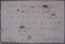 Foundation stone of a building in Shepherd's Bush showing Second World War shrapnel damage.