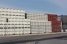 Apple field bins are stacked high at a processing facility in Wenatchee.