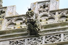 Grotesque with spectacles, Holy Cross church tower