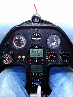 Schempp-Hirth Janus-C glider Instrument panel equipped for "cloud flying". The turn and bank indicator is top centre. The heading indicator is replaced by a GPS-driven computer with wind and glide data, driving two electronic variometer displays to the right. Glider Instrument Panel.png
