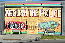 Graffiti and political messages on a boarded up store in Minneapolis, June 4 Graffiti Abolish the police, George Floyd protest, Minneapolis, MN, June, 2020.jpg