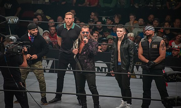 Jericho delivering a message to the crowd during AEW Dynamite in front of the newly formed Inner Circle faction in October 2019