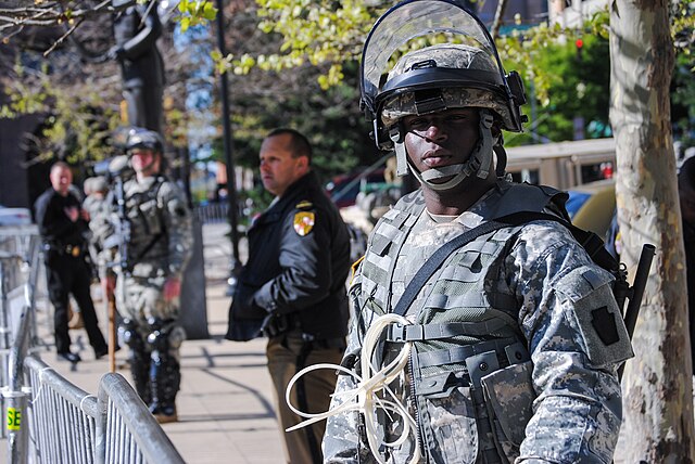A soldier from 1st Battalion, 175th Infantry Regiment keeps watch in front of Baltimore City Hall during the 2015 Baltimore protests