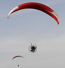 Two powered paragliders in flight