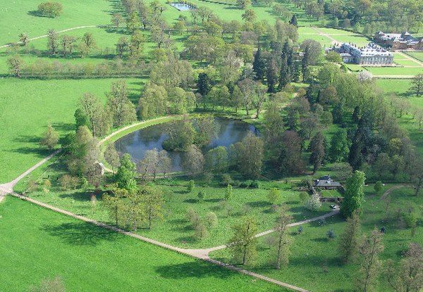 Aerial view of Althorp; the house is at top right. Diana is buried on the small tree-covered island in the middle of the ornamental Round Oval lake.
