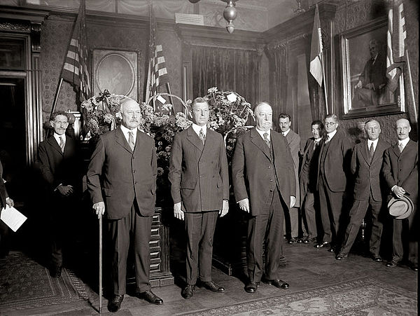 Swearing in of Dwight F. Davis as Secretary of War in 1925. Former Secretaries John W. Weeks and Chief Justice William Howard Taft are standing beside