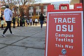 Sign at Oregon State University directing students to testing site TRACE OSU COVID-19 testing sign and students- 50624665398.jpg