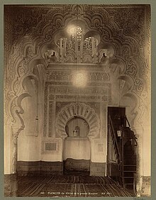 Mihrab area of the Great Mosque of Tlemcen, remodeled in 1136 under Ali ibn Yusuf. The mihrab is preceded by a large multifoil arch andis decorated with carved stucco. Above it, the decorative plaster cupola is partly visible. (Photo circa 1860) Tlemcen. Le mihrab de la grand Mosquee - ND. Phot. LCCN2004665073.jpg