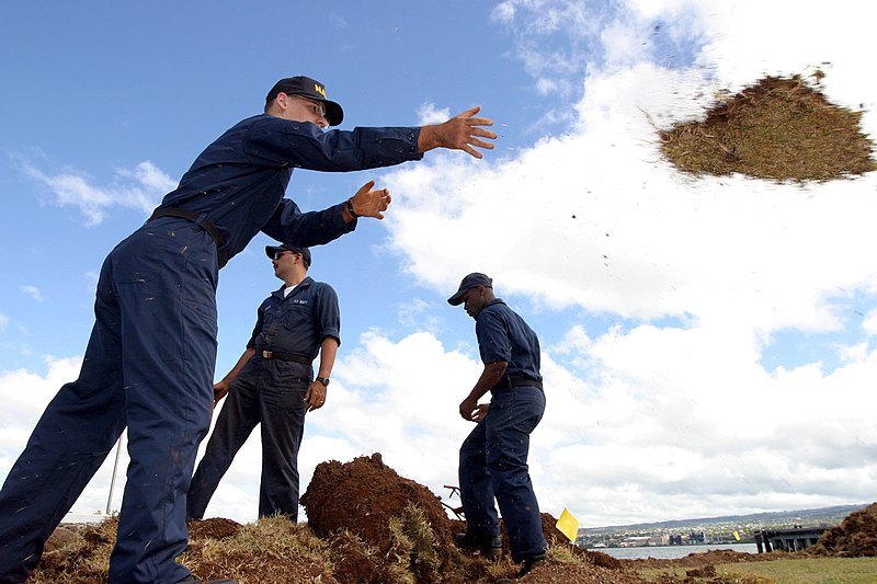 File:US Navy 030827-N-3228G-003 Seaman Eric Beitzel of Naval Station Pearl Harbor First Lieutenant Division throws sod the lawn of the USS Utah Memorial on Ford Island.jpg