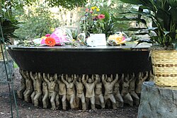 The Unsung Founders Memorial by a wreath and bouquets of flowers