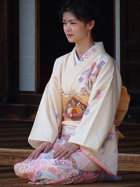 A Zen temple-goer wearing a formal cherry-blossom-motif kimono