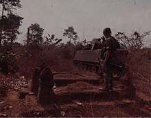 Men of the 1st Squadron 11th Armored Cavalry Regiment, halt their M-113s in a Vietnamese cemetery near Long Binh, 23 February 1969 11th ACR Tet 1969, February 1969.jpg