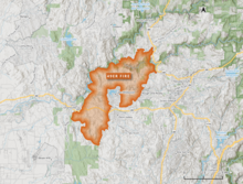 The 49er Fire footprint is shown in vivid orange, originating near Highway 49 and spreading down and to the left towards multiple towns against a white and green backdrop