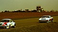 Aston Martin AM V8 - Derek Bell & David Preece chases Porsche 934 - Peter Zbinden & Edi Kofel at the 1979 Silverstone 6 Hours (50248776307).jpg