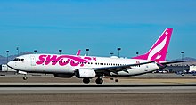 A Swoop Boeing 737-800. WestJet established the low-cost subsidiary in 2017, which ceased operations on 28 October 2023 due to its re-integration. C-FONK Swoop Boeing 737-8CT s n 40835 (39783249613).jpg