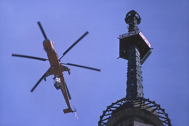 Helicopter lifting part of antenna, March 1975