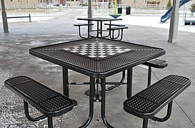 An outdoor chess table in a public park.
