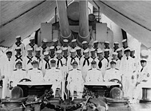 W.L. Lind (3rd from left) as commanding officer of USS Omaha, 1938-1939. Commanding Officer of USS Omaha (CL-4) with sailors aboard USS Omaha (CL-4), in 1938-1939 (NH 96029).jpg