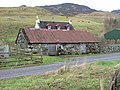 Croft in Upper Ardelve, a Highland settlement on Loch Alsh (2007). Image shows farmhouse behind a modest livestock shed. Cows graze the rear fields.