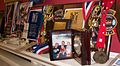 Medals, trophies, ribbons, plaques from weightlifting career.