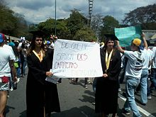 Graduates with a sign saying: "What use do I have of two careers in a dictatorship?". Graduates protesting Venezuela 2014.jpg