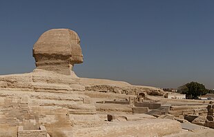 The forequarters of the Great Sphinx of Giza. The entrance to the Hall of Records is alleged to be near the sphinx's right paw (at lower right). Great Sphinx of Giza forequarters.jpg