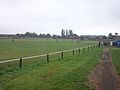 A freight train passes on the Sheffield to Lincoln Line behind the southern end of the Hard Lane ground