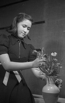 A woman creating a flower arrangement in the 1930s in Tokyo, Japan Lady arranging flower bouquet Tokyo 1930s.jpg