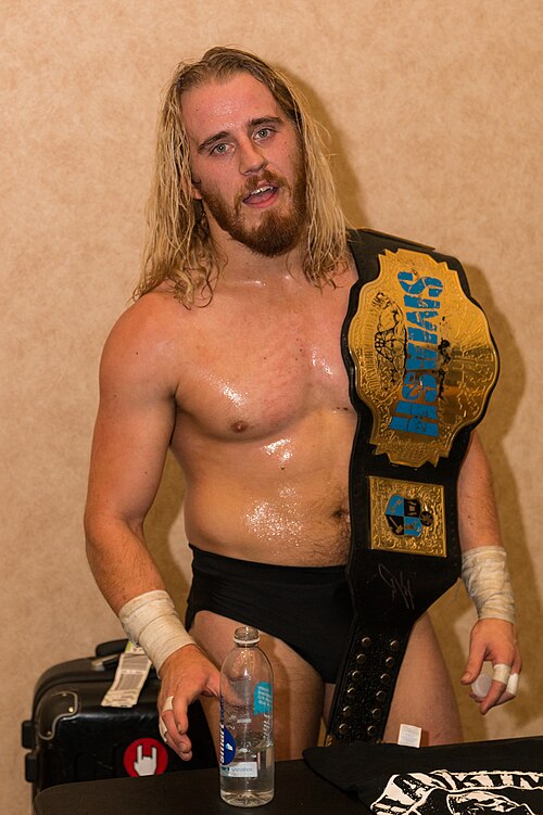 Haskins posing with the Smash Wrestling championship belt